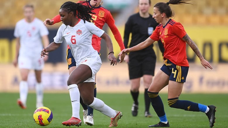Rose dribbles past two Spain players